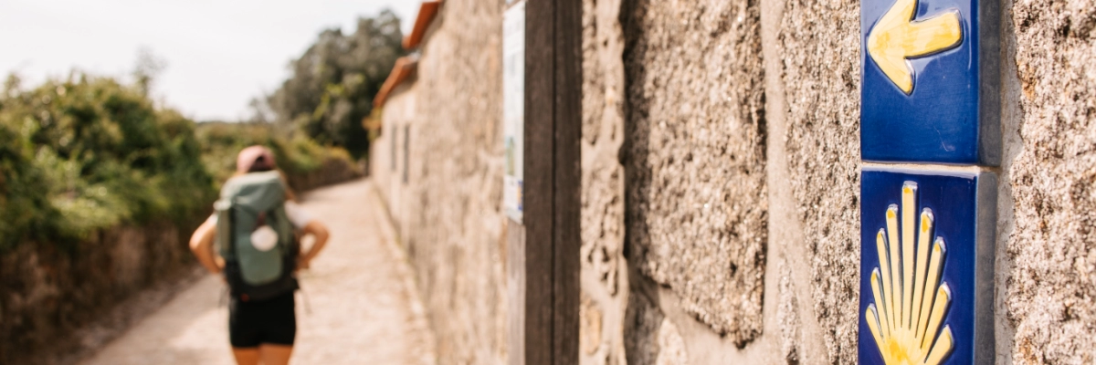 How can you combine the Camino de Santiago with a road trip in Portugal?