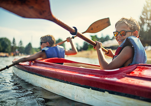 two boys canoeing on vacation