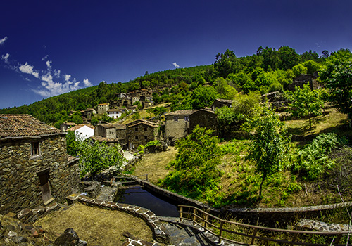 view over the vegetation and house in Schist Village in Portugal