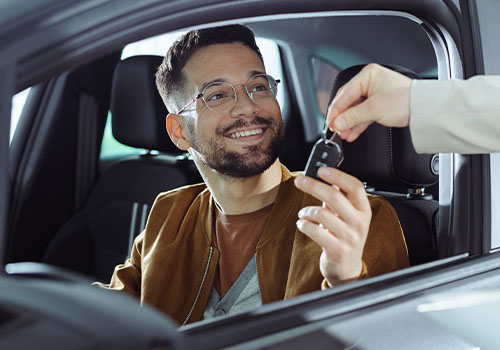 Man inside car receiving car key