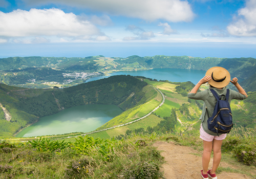 Woman observing the lagoon of the seven cities on the island of São Miguel