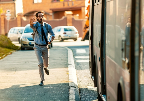 Young casual Businessman with backpack and book Running To Catch Bus Stop during summer day.