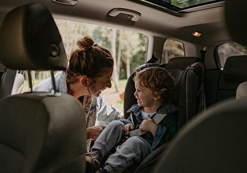 mãe e os dois filhos no carro