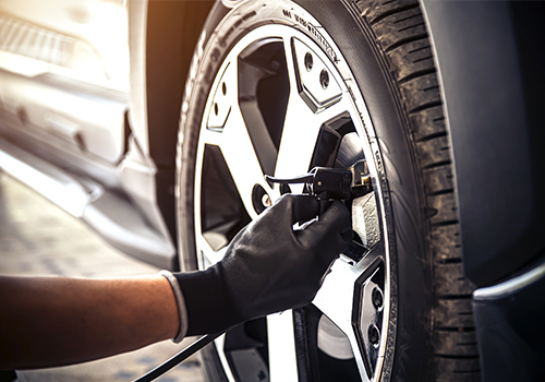 mechanic checking tire pressure