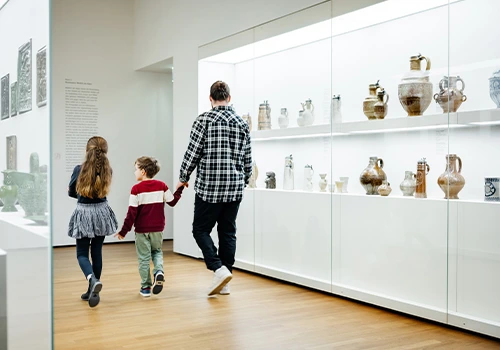 Father and two children visiting a museum on a rainy day