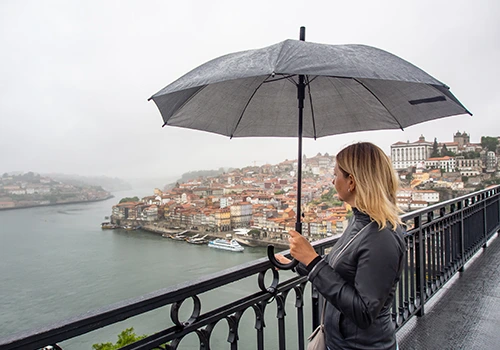 Tourist strolling in Porto on a rainy day