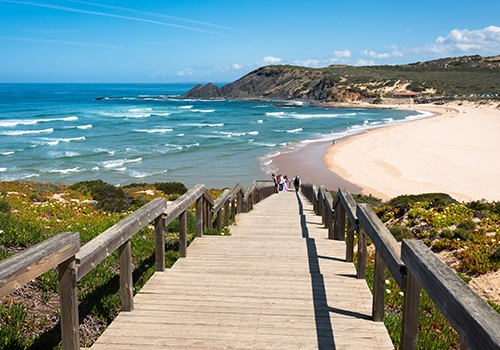 Wooden boardwalk overlooking a beach and the Atlantic Ocean on the Costa Vicentina.