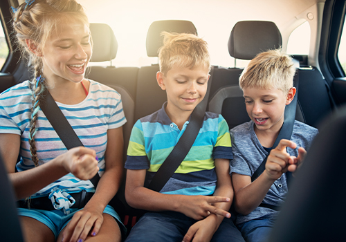 Crianças a jogar no carro durante uma viagem