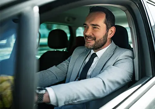 business professional driving a company car during daily work travel.