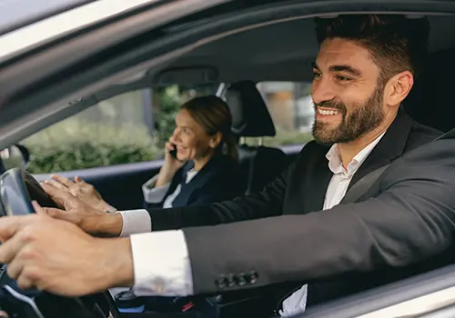 Business colleagues travelling together in a company car during work-related journeys