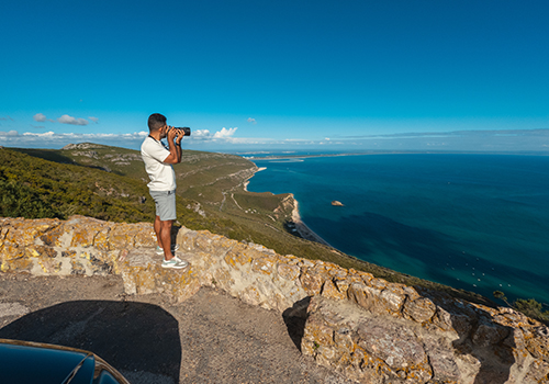 Tourist taking a photo from a viewpoint in Arrábida Natural Park