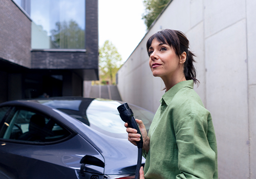 Businessperson charging their leased electric car