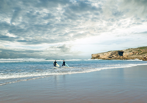 Surfers in the sea of Costa Vicentina.