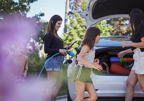 amily loading the boot for a holiday in a hired electric car