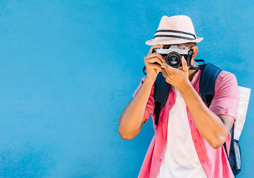 portrait male traveler taking photos